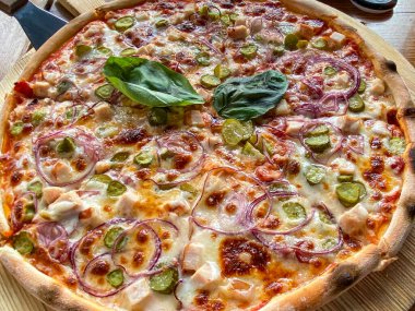 Restaurant Menu - Delicious Fresh Pizza. Pizza on Rustic Wooden Table with Ingredients. Tasty italian pizza.