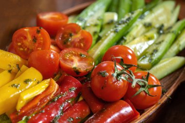 Sliced peppers, tomatoes and cucumbers, with herbs and butter.