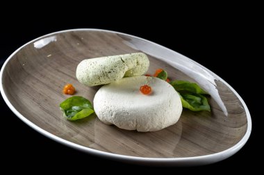 Fresh homemade spread cream cheese with herbs, garlic, chives and spices. Side view