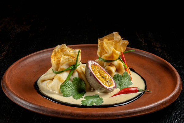 Pancakes stuffed with soyce and hot pepper. With delicious granadilla.