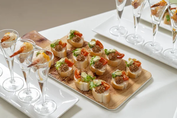 Catering, aperitivos en la mesa. Mini Sandwiches con paté y tomate, decorados con ensalada. —  Fotos de Stock