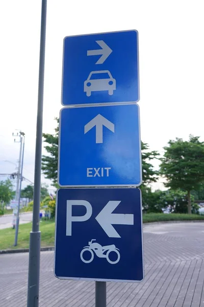 Photo of traffic signs, car and motorcycle parking positions and exits.