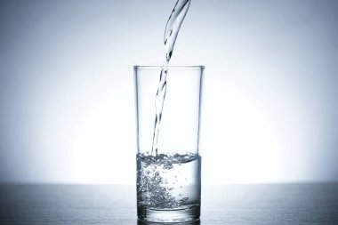 Bir bardak suya su dökme fotoğrafı.