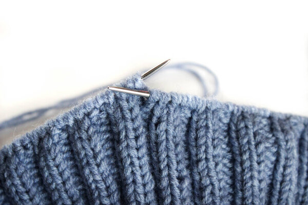 The process of knitting with needles. White background, on which you can easily place text or change the background