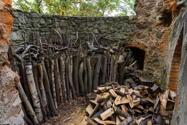 an old medieval brick castle wood store filled with wood for bur