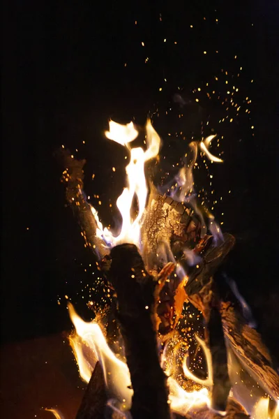 Fire pit fire at night with sparks