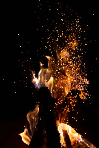 Fire pit fire at night with sparks