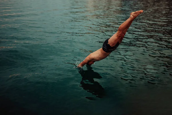 Man jumping into the ocean. Summer fun lifestyle.