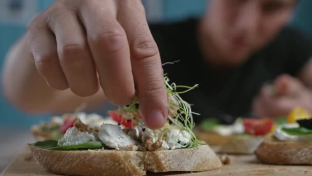 Jeune homme cuisine dans la cuisine apéritif. — Video