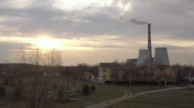 Arkaplanda ev ve ısı santrali var.