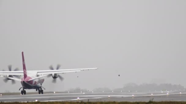 Het vliegtuig reist op de baan bij regenachtig weer — Stockvideo