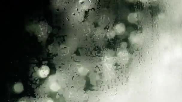 Abstract video of fogged glass on the background of which water — Wideo stockowe