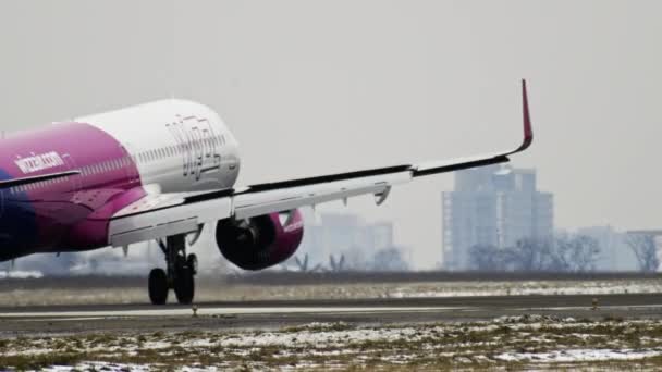 Большой самолет приземляется на взлетно-посадочную полосу зимой со снегом — стоковое видео