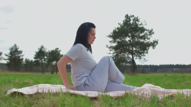 A girl alone with nature practices yoga. — Stock videók