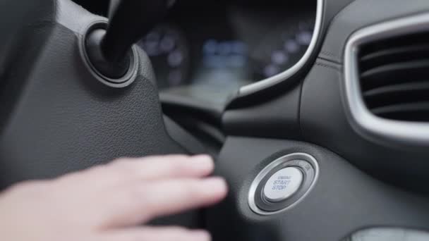 Female hand presses the stop button in the car. — Vídeo de Stock