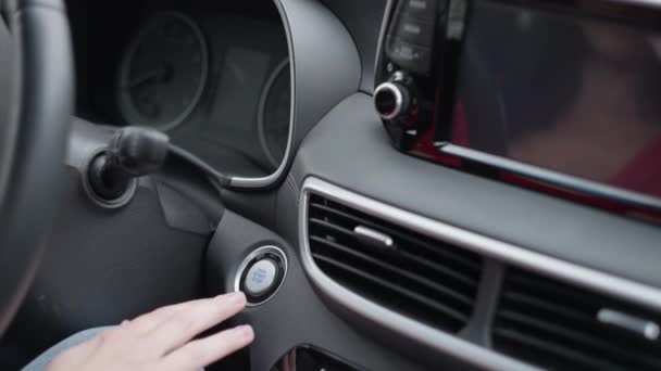 Close-up of a female hand pressing a car start button. — Stok video