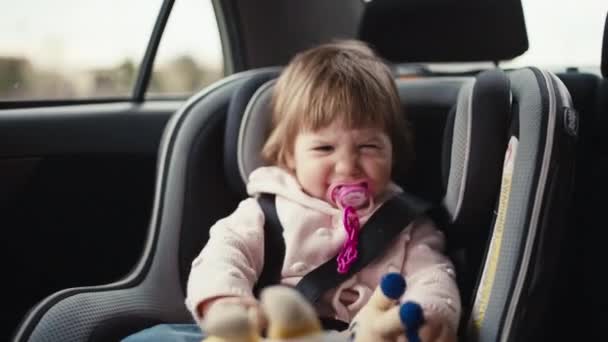 Dziewczyna Bawiąca Się Zabawkami Samochodzie Szczęśliwe Dziecko Podróżuje Rodzicami Foteliku — Wideo stockowe