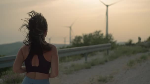 Una Ragazza Atletica Che Jogging Montagna Tramonto Mulini Vento Sullo — Video Stock