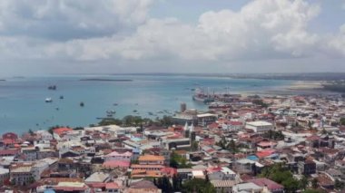 Stone Town 'daki sahil şeridinde uçan insansız hava aracı güzel eski caddeleri, evleri ve içinde teknelerin olduğu Hint Okyanusu' nu görebilirsiniz. Hava Çekimi Zanzibar Tanzanya.