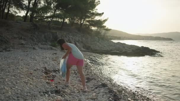 Girl Cleans Belts Garbage Woman Puts Plastic Waste Garbage Bag — Stockvideo