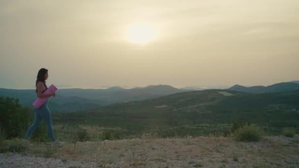 Menina Com Tapete Vai Fazer Ioga Nas Montanhas Pôr Sol — Vídeo de Stock