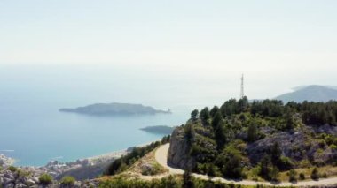 İnsansız hava aracı videosu Budva, Karadağ. Dağların ve tepe kentlerin havadan görünüşü, deniz körfezi, ada ve Adriyatik Denizi. Yüksek kalite 4k görüntü
