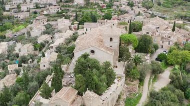 Architecture of European old village dron 4K video. Aerial view of a landscape with historic buildings and houses with tiled roofs on the streets where trees grow. High quality 4k footage