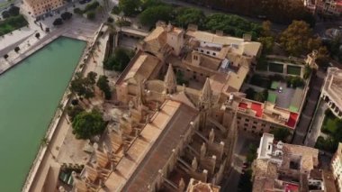 Historic cathedral dron 4K video. Aerial view of a gothic style church building that stands in the center of the city with streets and old houses in Palma on the island of Mallorca in Spain.