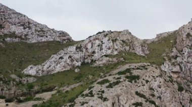 Okyanus dronu 4K videosunun Rocky sıradağları. Arka planda güzel bir manzara için dağların, tepelerin ve çalı ve çimlerle kaplı yamaçların havadan görünüşü. Yüksek kalite 4k görüntü