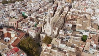 Architecture of the Catholic Church dron 4K video. Aerial view of a historic Gothic cathedral standing in the heart of the city surrounded by old houses in a landscaped location.