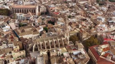 Architecture of a historic European city with a cathedral dron 4K video. Aerial view of the old church standing in the city center with houses, roofs, beautiful urban landscape.
