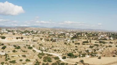 Aerial landscape view in Cyprus. villages with houses, streets, agricultural fields and plantations at the foot of mountains and mountain range. High quality 4k footage