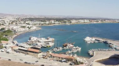 Drone flying over the marina in the Mediterranean Sea, where there are fishing boats, yachts and ships parked in the port. Aerial view Paphos Cyprus. High quality 4k footage