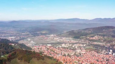 Aerial shot Bosnia and Herzegovina. Drone video of landscape mountainous terrain with mountain ranges on which there are villages with houses and roads, mountain peaks and textured sky.