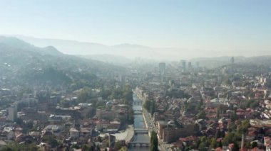 Downtown with downtown, old historic buildings and streets with backgrounds on mountain ranges. Aerial view of Sarajevo Bosnia and Herzegovina.