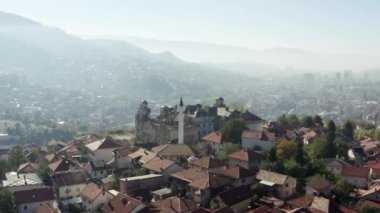 Bosna-Hersek 'i hava saldırısı vurdu. Avrupa şehrinin merkez kısmının insansız hava aracı videosu. Tarihi binalar, tepelerde evler, arka planda nehirler ve dağlar..
