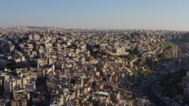 Drone video of cityscape in Arabic style. Houses on the slopes of the mountains with streets in the Middle East. Aerial view Amman Jordan. High quality 4k footage