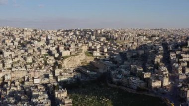 Drone video of a historic city in the Middle East in Arabic style. Houses in the mountains with streets in the city center. Aerial view Amman Jordan. High quality 4k footage