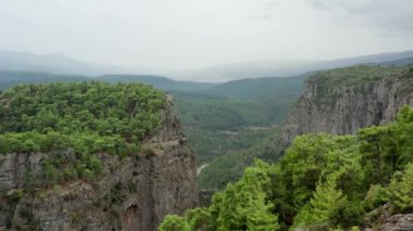 Drone video of a beautiful canyon with cliffs. Rocky mountains and ridges among which a cliff with rocks and stones. Aerial view Antalya Turkey. High quality 4k footage