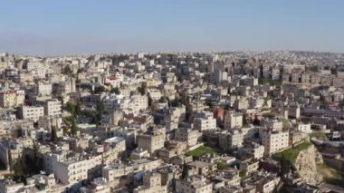 Drone video Amman Jordan. Downtown is a city with old houses, historic streets and Arabic architecture. Aerial view of cityscape in mountainous terrain. High quality 4k footage