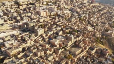 Drone video of the streets of the historic city with mosques and houses. Misopotamia architecture in cityscape with buildings. Aerial view Mardin Turkey. High quality 4k footage