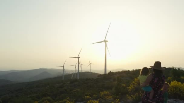 Aerial View Mom Children Stands Shows Them Windmills Sources Clean — Vídeo de stock