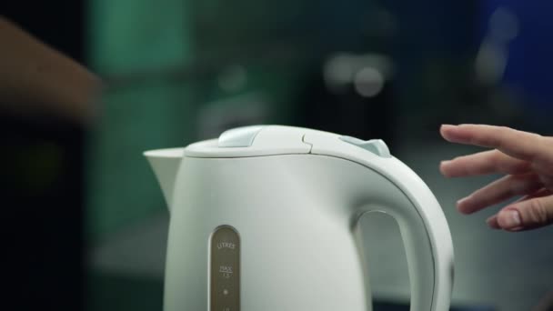 Female Hand Turns Electric Kettle Button Process Boiling Water Kettle — Vídeos de Stock