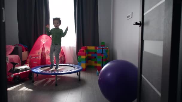 Boy Playing Game Room Home Child Jumps Trampoline Smiles Rejoices — Stock Video
