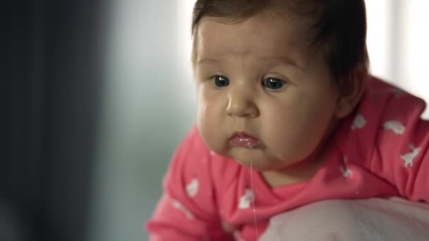 Little Girl Moms Arms Baby Looks Camera Saliva Flows Her — Videoclip de stoc