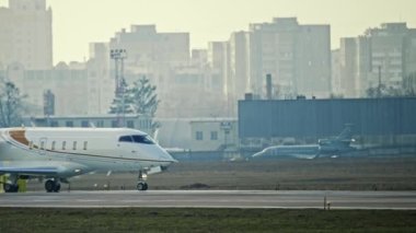 A small private plane travels along the runway. Slow motion 4K video of an airplane at the airport.