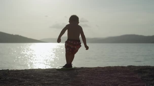 Boy Stands Surfboard Beach Ocean Child Actively Spends Rest Sea — Video Stock