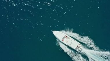 Aerial view of a motor boat sailing on the sea. A luxury yacht rides fast on the waves of the ocean. High quality 4k footage