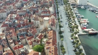 Aerial view Split Croatia. The embankment in the historic center of the city with trays moored to the piers and old historic houses, palm trees and pedestrian streets. High quality 4k footage