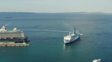 Aerial view of a cruise ship entering the port. A large tourist ship during a cruise in the sea. High quality 4k footage